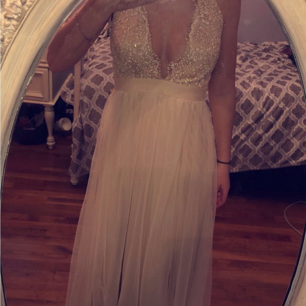 Long sheer ivory gown with lace bodice.